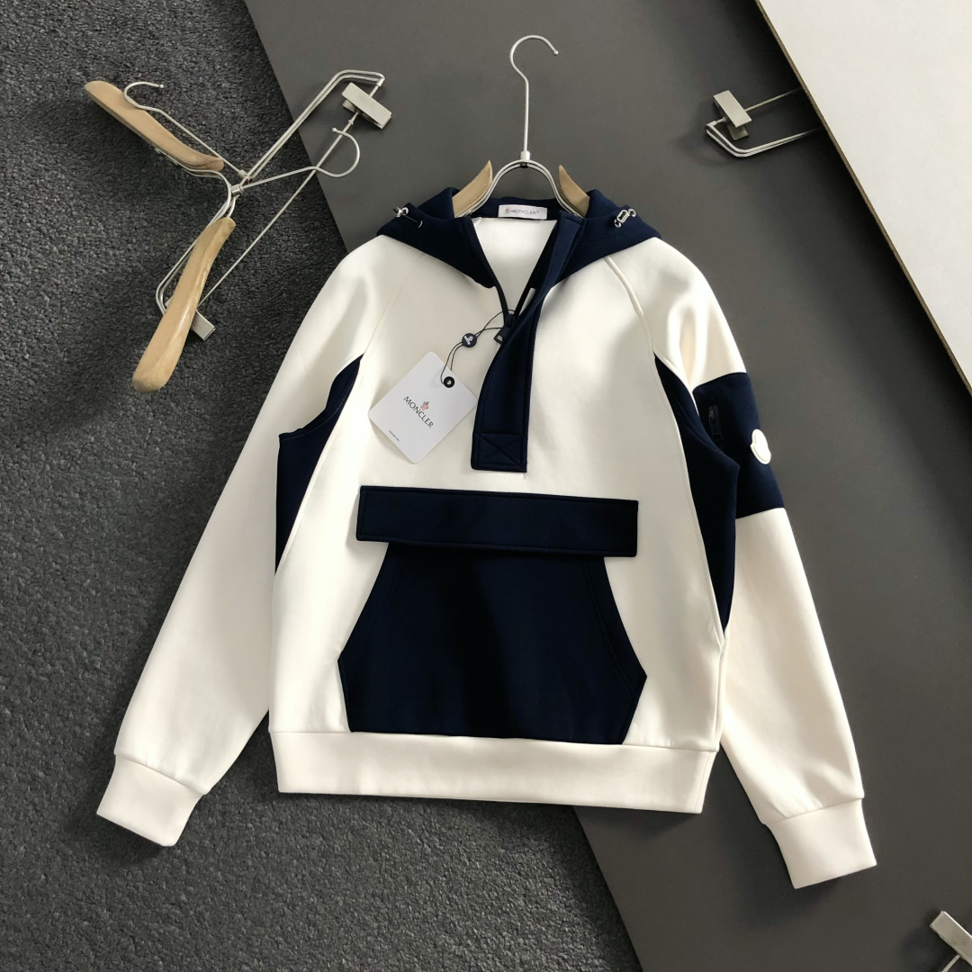 Mon*合身版型M-XXXl2025秋冬潮牌云柔系列连帽卫衣，以红黑撞色融合皮牌点缀为主调，巧妙融入多拼