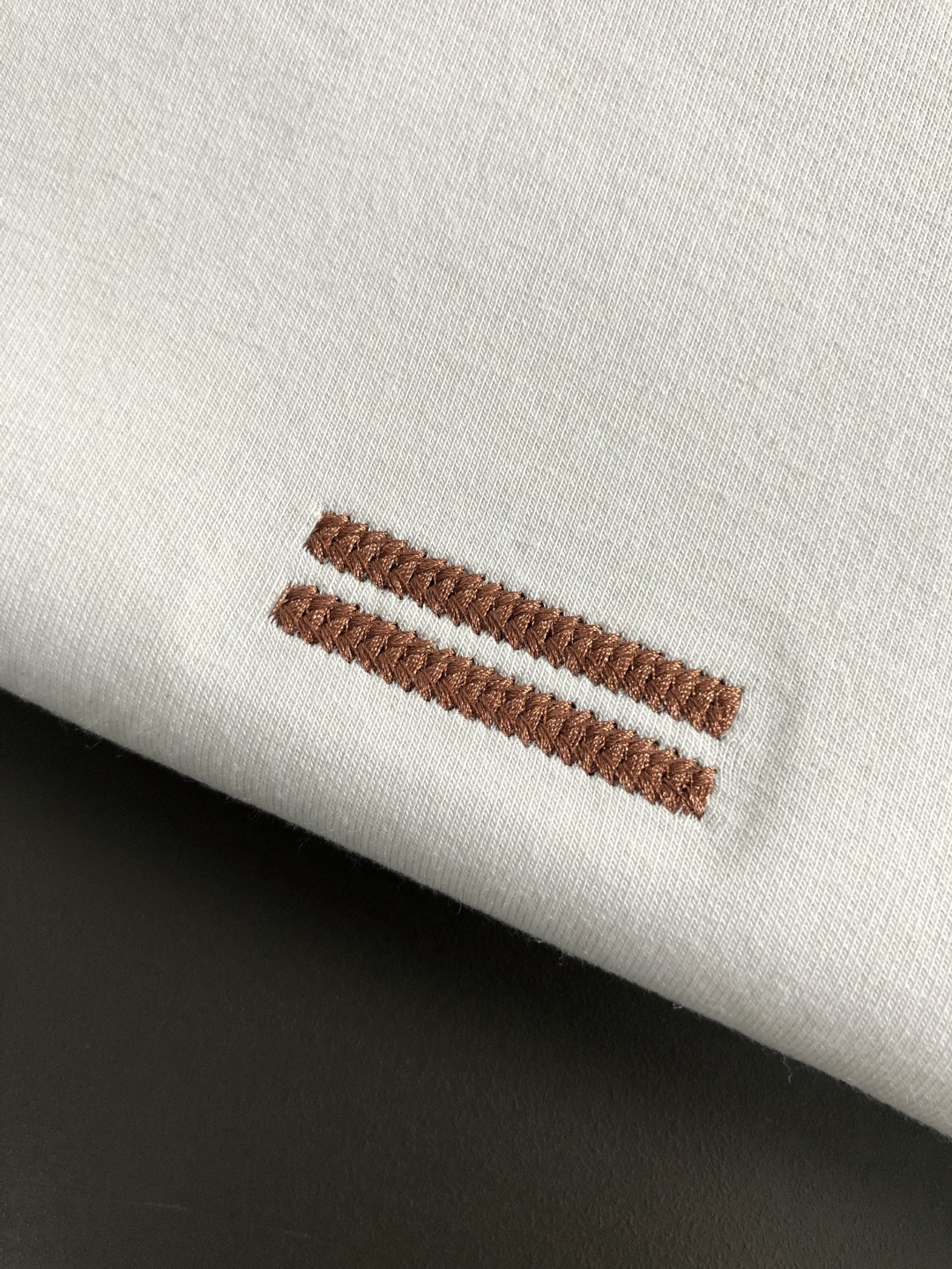 Zeg*合身版型M-xxxl2025秋冬圆领打底衫，以咖色贴布绣点缀为主调，融入双杠元素，打破传统卫衣的