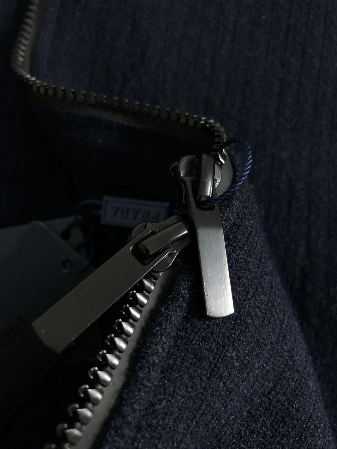 Prad*微宽版型M-XXXl2025秋冬潮牌针织开衫，以金属三角标点缀为主调，巧妙融入坑条撞色螺纹领拼