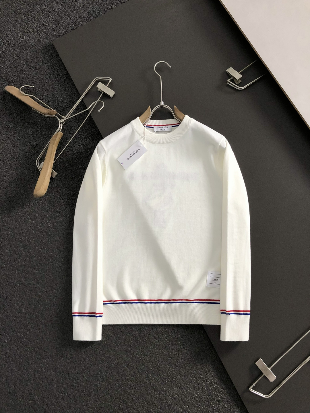 TB*合身版型M-XXXl2025秋冬潮牌圆领羊毛衫，以红黑撞色织带融合皮牌点缀为主调，巧妙融入后幅字母