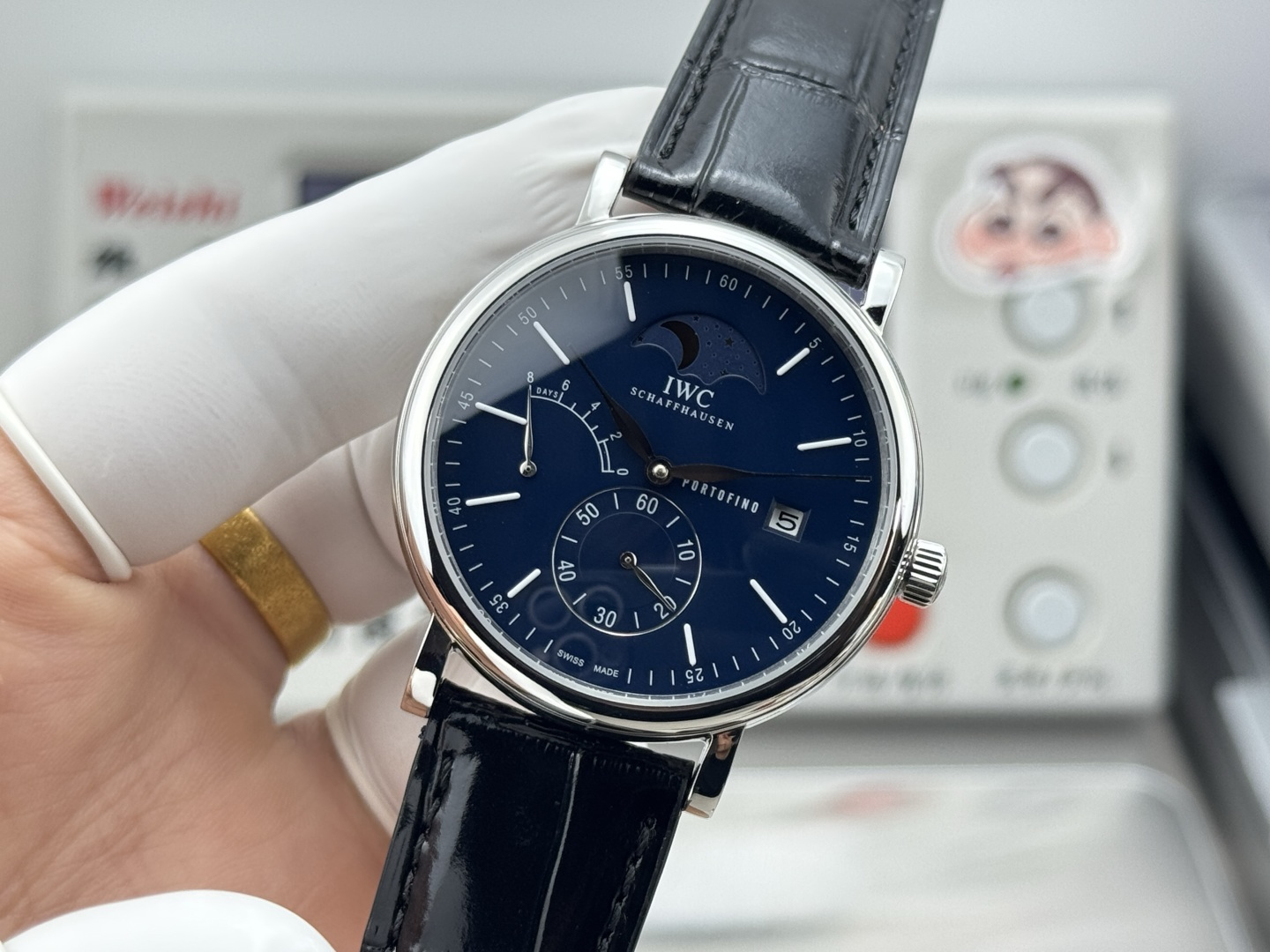 IWC Portofino Hand-Wound Moon Phase stainless steel case, black dial, black leather strap 45mm Men's Mechanical