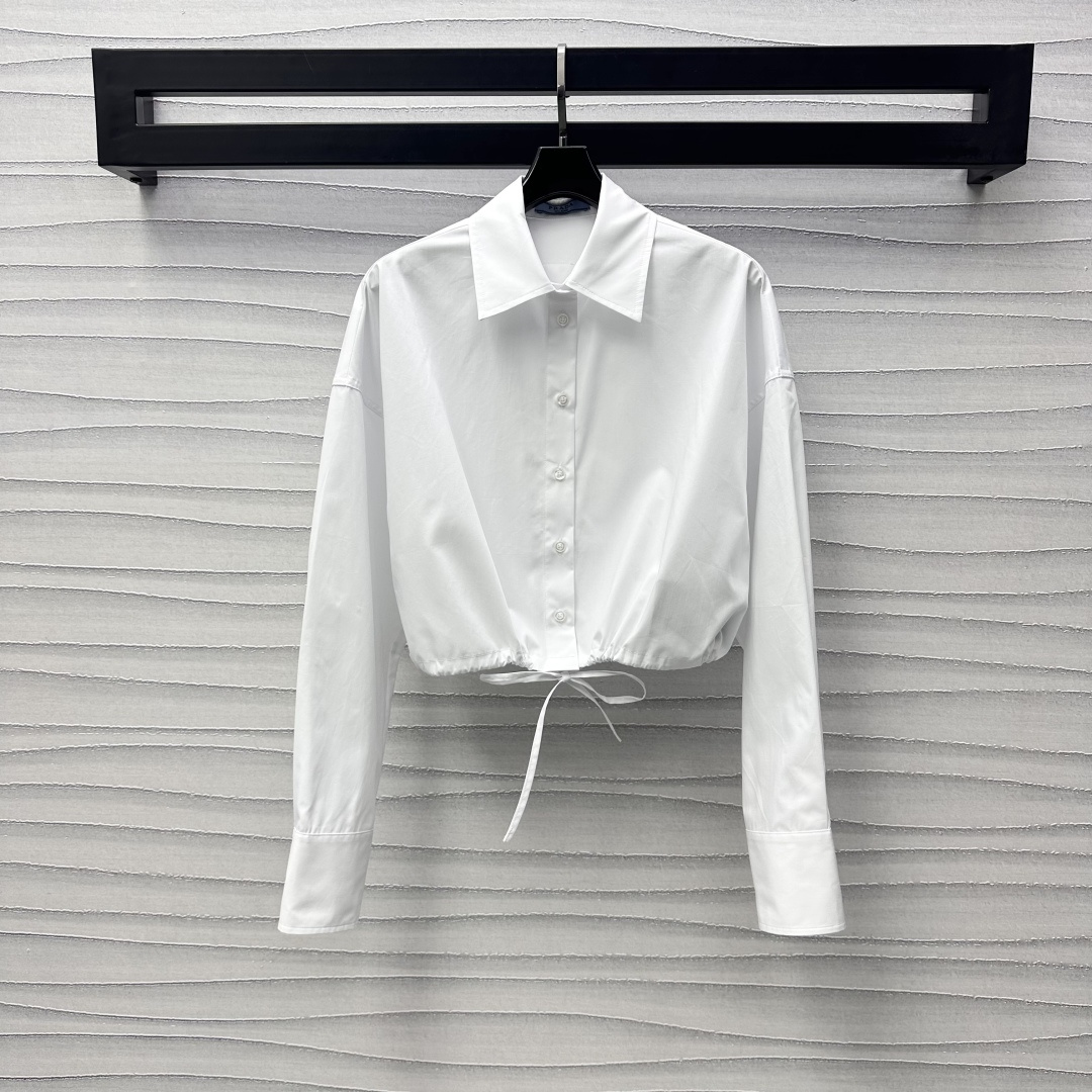 NO:309689,Prad*2025 new product launch drawstring short shirt custom YB imported twill cotton material, soft and skin-friendly, comfortable and not easy to wrinkle, decorated with a drawstring adjustment design to add layering, the iconic triangle markings behind it embellish the brand tone, presenting the exclusive well-behaved college style, surface auxiliary material development, short shirt style cut, casually matched with pants skirt, short top and long bottom easily highlighting the charm of long legs, high version, prada, skirts, shirts, alexander wang19860909Prad*2025新品上架抽绳短款衬衫定制YB进口斜纹全棉材质 柔软亲肤 舒适不易皱 饰以衣摆抽绳调节设计 增添造型层次感 背后标志性三角标点缀装饰 彰显品牌调性 呈现专属乖巧学院风格 面辅料开发 短款衬衣版型剪裁 随意搭配裤子半裙 上短下长轻松突出长腿魅力  高版本,,prada,skirts,shirts,alexander wang,Women's clothing