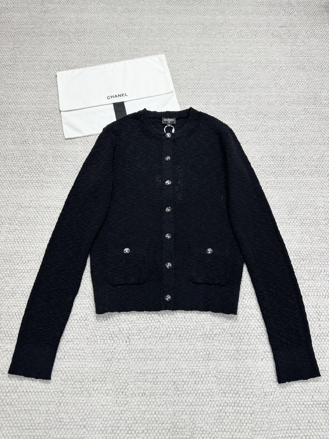 Elegant Coco Beach Black Knit Cardigan with Button Detail and Tailored Fit