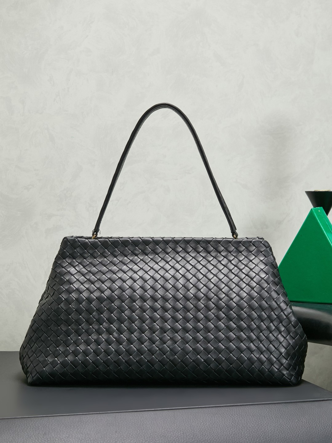 The 1998 gold clip handbag is named in tribute to the highlight of the brand's first show in Milan in 1998. It replicates the retro silhouette of the Frame Bag in the 1990s. The trapezoidal bag body is soft but not collapsed. It is made of Nappa lambskin with a dense and soft texture. The leather surface is delicate and wear-resistant. The top is opened and closed with an integrated metal square buckle. The sides are naturally slightly closed. It comes with a small mirror and the opening and closing method is calm and elegant. Minimalist design without logo, elegant and restrained, suitable for commuting or dinner, gentle and aura.
Style number: 868128
Color: black
Size: 37*18*16cm