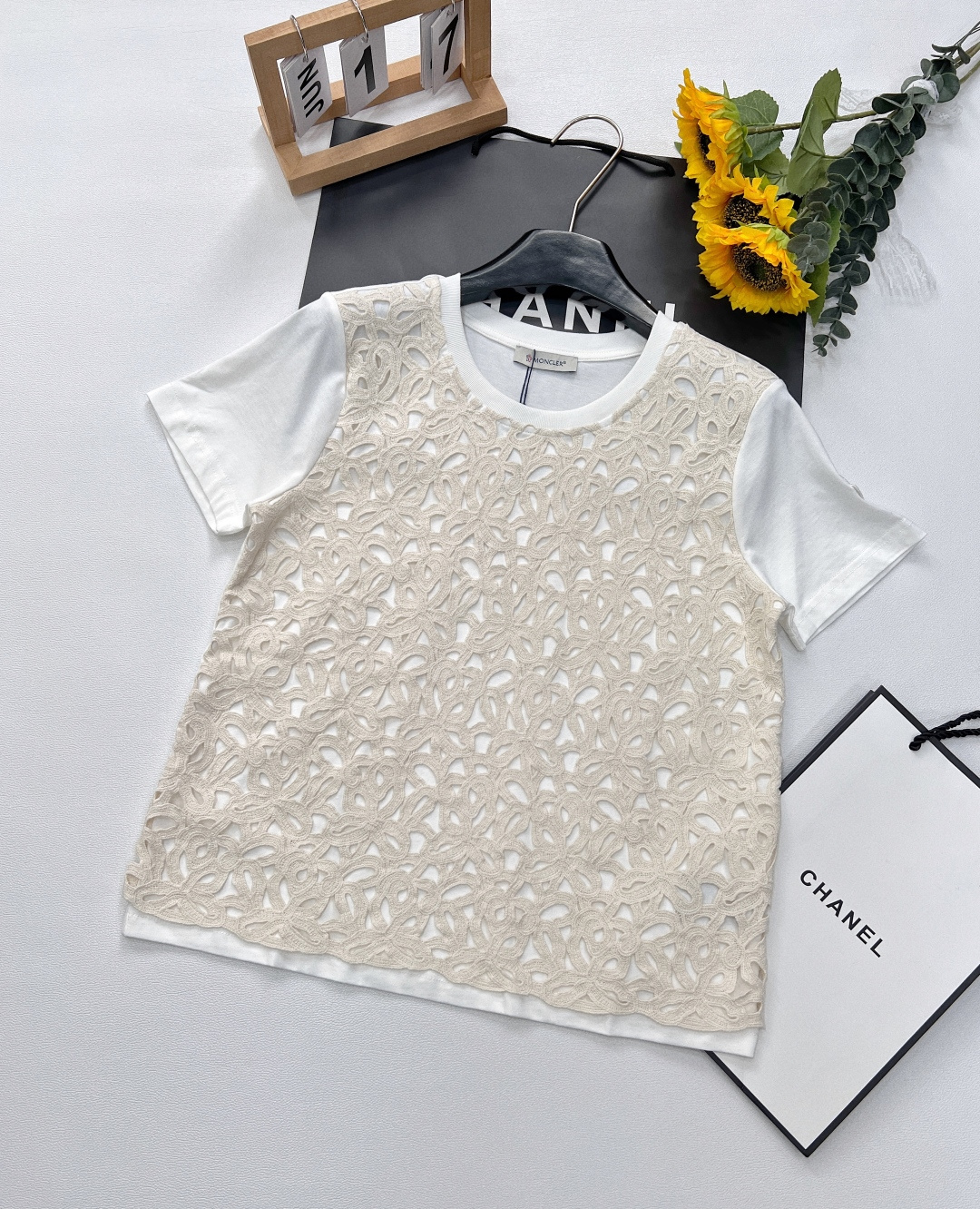 NO:327439,The top skirt Moncler Spring and summer new lace suit is a masterpiece of fashion and ingenuity. The top is based on a pure white T-shirt and has a short-sleeved design, bringing a refreshing and comfortable feeling. The lace part is equipped with a customer-supplied specific water-soluble lace fabric, carefully crocheted from cotton yarn, with a soft texture without losing its clarity. The exquisite crochet and interwoven jacquard pattern are complex and reworked to demonstrate extraordinary quality and integrate the brand style into every detail.  The lace skirt paired with the lower body continues the exquisite lace craftsmanship of the top, and the high-waist design cleverly outlines the waistline to show a graceful posture. The length of the skirt is elegantly placed on the calves. While walking, the lace swings lightly, agile and charming, and the details of the slit add a bit of casualness and playfulness. It is simple and atmospheric and full of texture. Whether you are strolling on the streets of spring or attending important social occasions, this masked lace suit can make you the focus and perfect interpretation!  Single!  Size sml, Moncler, skirts, T-shirt,tees, t-shirt,alexander wang19860909上衣半裙Moncler 春夏新款蕾丝套装,是时尚与匠心交织的杰作.上衣以纯净白色T恤为基底,短袖设计,带来清爽自在之感.外搭蕾丝部分,采用客供特定水溶花蕾丝面料,由棉质纱线精心钩织而成,质地松软却不失挺括.精致的钩花与交织提花图案,繁复重工,彰显非凡品质,将品牌格调融入每一处细节. 下身搭配的蕾丝裙,延续上衣的精美蕾丝工艺,高腰设计巧妙勾勒腰线,展现曼妙身姿.裙身长度优雅落于小腿处,行走间,蕾丝轻盈摆动,灵动而迷人,开叉细节又增添了几分随性与俏皮.简洁大气,质感十足.无论是漫步在春日街头,还是出席重要社交场合,这套蒙口蕾丝套装都能让您成为焦点,完美诠释！单出！ 尺码sml,,Moncler,skirts,T-shirt,tees，t-shirt,alexander wang,Women's clothing