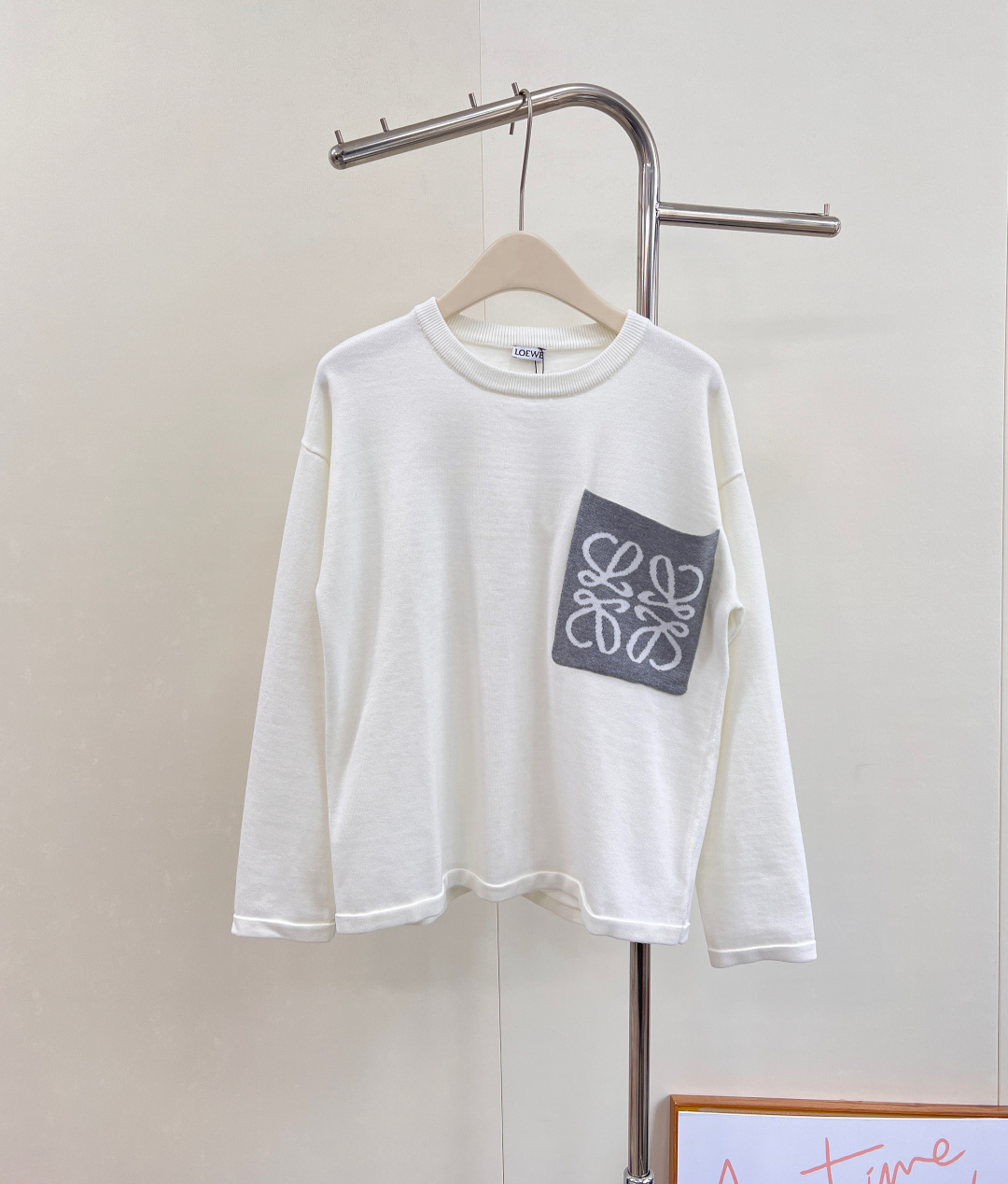 NO:560512,LOEWE logo contrast chest pocket wool sweater, a lazy look in autumn. The cream white is too gentle~ The contrast logo design on the chest is very clever and breaks the monotony. The fine wool material is selected, soft and warm in winter, and the simple tailoring hides high-end tension. One piece unlocks the dual charm of laziness and sophistication. Simple and fashionable, very tonal. The round neck pullover is classic and versatile. The loose style will look taller and slimmer with any bottom.  It is very friendly to girls with imperfect body shapes and small girls. It can be worn alone in early autumn. It is simple and medium-toned. It is fashionable and high-end. It is loosely tailored to outline a lazy silhouette. It has three standards and is sold in large quantities. Size SML code L, loewe, alexander wang19860909LOEWE logo撞色胸前口袋羊毛针织衫,入秋的慵懒感穿搭 奶油白色也太温柔了叭～ 胸前的撞色logo设计很有巧思,打破单调感 精选细腻羊毛材质,柔软裹挟冬日暖意,简约剪裁中暗藏高级张力.一件解锁慵懒与精致的双重魅力 简约时髦 非常有调性 圆领套头经典百搭 宽松款搭配任何下装都会显高显瘦 对身形不完美和小个子女生都很友好 早秋单穿 简约中调性十足 时髦又高级,宽松剪裁勾勒慵懒轮廓,三标齐全,大货出 尺码sml 编码L,,loewe,alexander wang,Women's clothing