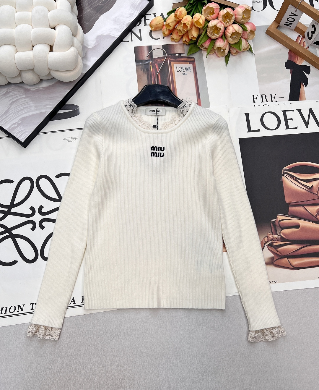 NO:686604,Miumiu's new letter embroidery and lace knitted bottoming shirt. The Miumiu knitted bottoming shirt is both gentle and delicate. It is an excellent choice for autumn and winter. The vertical grooved knitted fabric fits the body shape, outlines neat lines, and has a soft and skin-friendly feeling. The lace stitching on the collar and cuffs is kneaded into  The sweet element breaks the monotony of basic models; the miu letter embroidery on the chest is the brand logo, which is simple and recognizable. The three colors of black, gray and off-white are classic and versatile. Whether worn alone or layered with coats and suits, you can easily create an elegant and casual daily look. Complete with three labels, three colors are outstanding  Size sml code M,,miumiu,business suit,19860909Miumiu新款字母刺绣拼蕾丝针织打底衫,温柔与精致并存的缪缪针织打底衫,是秋冬内搭的绝佳选择.竖坑条针织面料贴合身形,勾勒出利落线条,兼具柔软亲肤的穿着感；领口与袖口的蕾丝拼接,揉入甜美元素,打破基础款的单调；胸前的miu字母刺绣是品牌标识,简约中透着辨识度.黑、灰、米白三色经典百搭,无论是单穿还是叠穿大衣、西装,都能轻松打造优雅又随性的日常造型.三标齐全,三色出 尺码sml 编码M,,miumiu,business suit,,Women's clothing