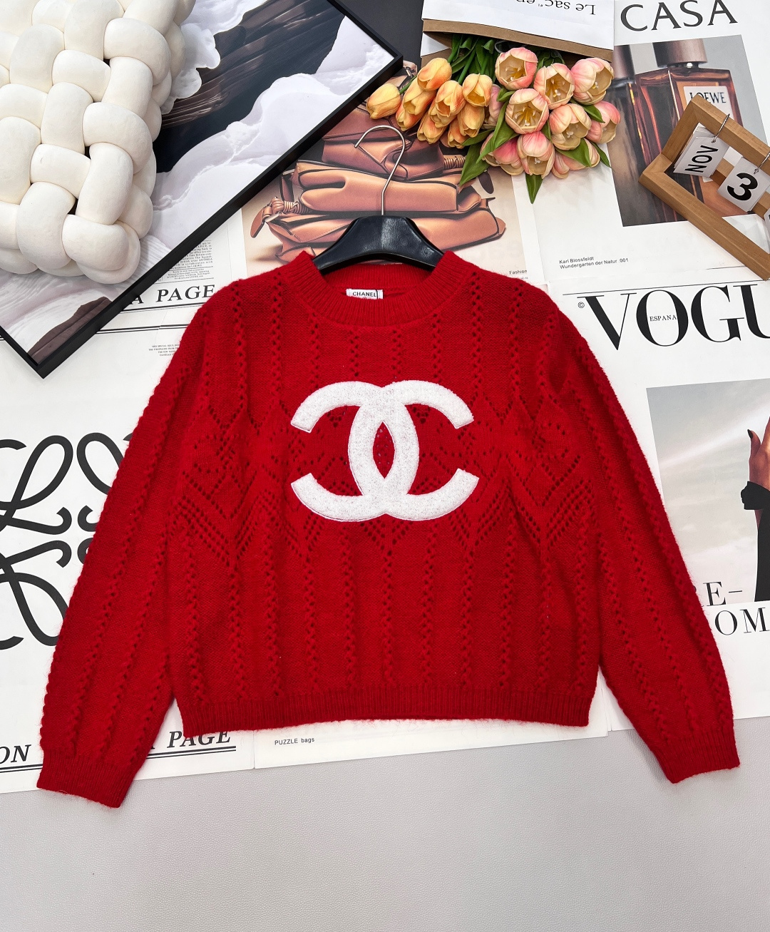 NO:696346,CHANEL26's new pure red hollow sweater, red rhombus, C position heartbeat, a touch of pure red hits the line of sight, classic round neck outlines the neck line, loose long sleeves adapt to various body shapes, lazy and casual with exquisite style.  The diamond-lattice hollow texture is the finishing touch, and the delicate knitted holes create a gentle texture, making the red color no longer monotonous, and adding layers and breathability; the double C three-dimensional patch embroidery on the chest is three-dimensional and full, becoming the visual focus and instantly heightening the style recognition. The soft and waxy knitted touch is skin-friendly and comfortable, and the true red tone is suitable for the warm atmosphere of festival wear, and can be easily worn alone or layered for daily use. Three labels are complete, and large quantities are available. Size sml  Editor,,chanel,19860909CHANEL26新款正红镂空针织衫,红韵菱格,C位心动,一抹正红撞入视线,经典圆领勾勒颈部线条,宽松长袖适配各种身形,慵懒随性中透着精致格调. 菱格镂空肌理是点睛之笔,细腻的针织孔洞织就温柔质感,让红色不再单调,层次与透气感双双拉满；胸前双C立体贴布绣立体饱满,成为视觉焦点,瞬间拉高造型辨识度. 软糯的针织触感亲肤舒适,正红色调既适配节日穿搭的热烈氛围,日常单穿或叠搭也能轻松出彩,三标齐全,大货出 尺码sml 编,,chanel,,Women's clothing