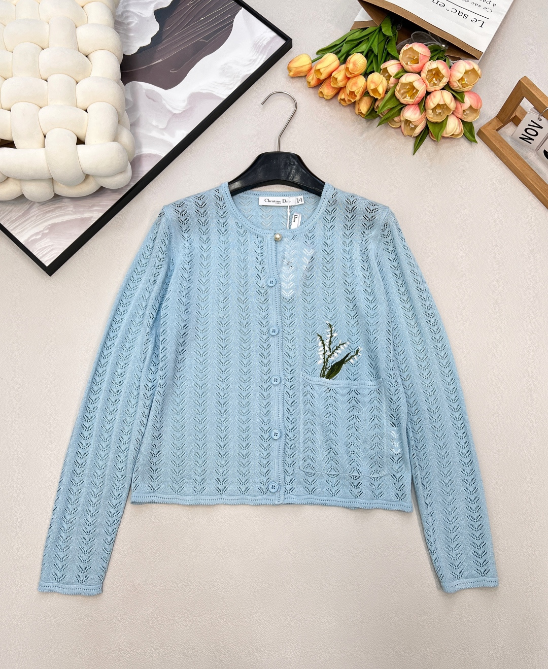 NO:708742,Dior2026 new embroidered lily of the valley flower knitted cardigan, custom-made YB cotton yarn weaving, ultra-density processing, soft and waxy texture, stretchy and comfortable, sky blue knitted cardigan is a fresh and romantic prelude!  The transparent ice blue tone is gentle and healing, the exquisite diamond hollow texture outlines the light texture, and the floral embroidery on the pocket is the finishing touch, quietly revealing French elegance. Pearl buttons embellish the placket, and the soft and waxy knitted fabric is skin-friendly and breathable. It can be worn with suspenders or dresses to easily create a gentle and delicate look. It is an atmospheric layering artifact in the wardrobe. Three standards are complete, and large quantities are available. Size sml  coding,,dior,skirts,19860909Dior2026新款刺绣铃兰花针织开衫,定制YB棉毛纱线织造,超密度处理,质感软糯,弹力舒适,天蓝针织开衫是清新浪漫序曲！通透的冰蓝色调温柔又治愈,精致的菱格镂空纹理勾勒出轻盈质感,口袋处的花卉刺绣更是点睛之笔,悄然流露法式优雅.珍珠纽扣点缀门襟,软糯的针织面料亲肤又透气,搭吊带、配连衣裙都能轻松打造温柔又精致的造型,是衣橱里的氛围感叠穿神器.三标齐全,大货出 尺码sml 编码,,dior,skirts,,Women's clothing