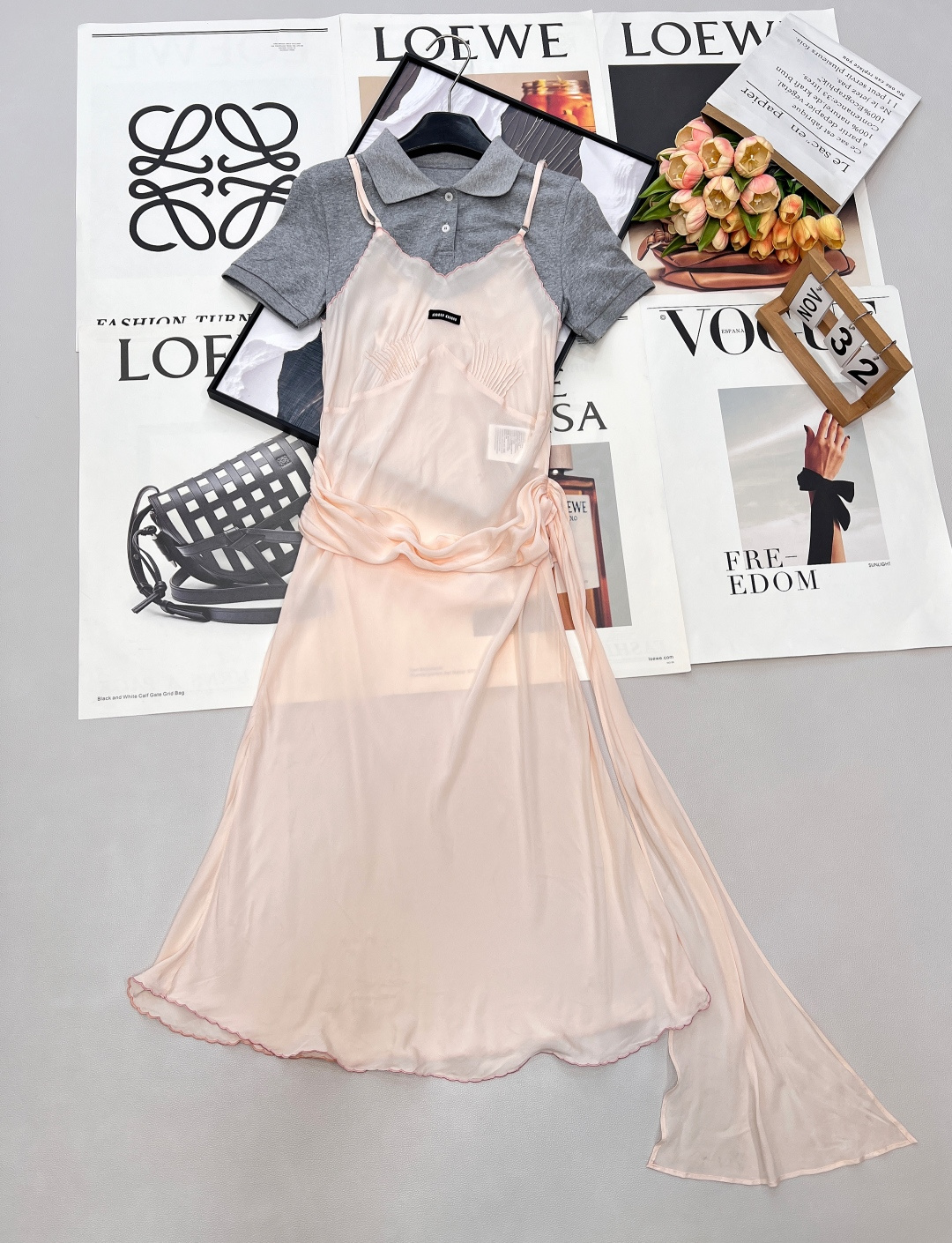 NO:731886,Miumiu26SS new early spring fake two-piece Polo collar spliced suspender dress, this is a fairy dress with its own 'atmosphere'. It perfectly combines the casual and casual Polo short sleeves with the soft and sexy suspender skirt to create a sweet and cool college pure desire style. It is a fashionable item that cannot be missed this summer. -  The Polo short-sleeve part is made of heavy combed cotton fabric, which feels soft and skin-friendly, stiff and not easy to deform. The classic gray tone comes with a retro filter, which is easy to wear every day. - The suspender skirt part is made of high-gloss acetate satin, which is silky and draped, as light as a cloud. The apricot color glows with gentle luster under the light, making the skin white and translucent. -  The exquisitely detailed contrast stitching on the edge of the skirt and the scalloped pleats on the chest add a delicate sense of craftsmanship to the whole, highlighting the quality in a low-key manner. - The neat Polo collar of the fake two-piece splicing design neutralizes the sexiness of the suspender skirt, and the smooth skirt eliminates the toughness of the Polo shirt, easily achieving a 'sweet-cool balance'. -  The twist design of the twist ribbon on the waist side can be adjusted freely, which can not only accurately outline the waistline, but also create a lazy and casual sense of relaxation, which is friendly to all body types. - The irregular and slightly slanted skirt is light and elegant when walking, with its own dynamic beauty, injecting a smart atmosphere into the shape. Three standards are complete, and large quantities are shipped. Sizes are sml, miumiu, skirts, T-shirt,19860909Miumiu26SS早春新款假两件Polo领拼接吊带连衣裙,这是一件自带“氛围感”的神仙裙装,把休闲随性的Polo短袖和柔媚性感的吊带裙完美融合,打造出又甜又酷的学院纯欲风,是今年夏天不可错过的时髦单品. - Polo短袖部分采用重磅精梳棉面料,触感软糯亲肤,挺括不易变形,经典灰色调自带复古滤镜,日常好搭不挑人. - 吊带裙身部分选用高光泽醋酸缎面,丝滑垂坠,如云朵般轻盈,奶杏色在光线下泛着温柔光泽,衬得肤色白皙透亮. - 精致细节裙身边缘的撞色线迹与胸前的扇形褶皱,为整体增添了细腻的手工感,低调彰显品质. - 假两件拼接设计利落的Polo领中和了吊带裙的性感,柔滑的裙身又消解了Polo衫的硬朗,轻松实现“甜酷平衡”. - 腰侧扭结飘带可自由调节的扭结设计,既能精准勾勒腰线,又能营造慵懒随性的松弛感,对各种身材都很友好. - 不规则裙摆微斜的裙摆走动间轻盈飘逸,自带动态美感,为造型注入灵动气息.三标齐全,大货出 尺码sml 编,,miumiu,skirts,T-shirt,,Women's clothing