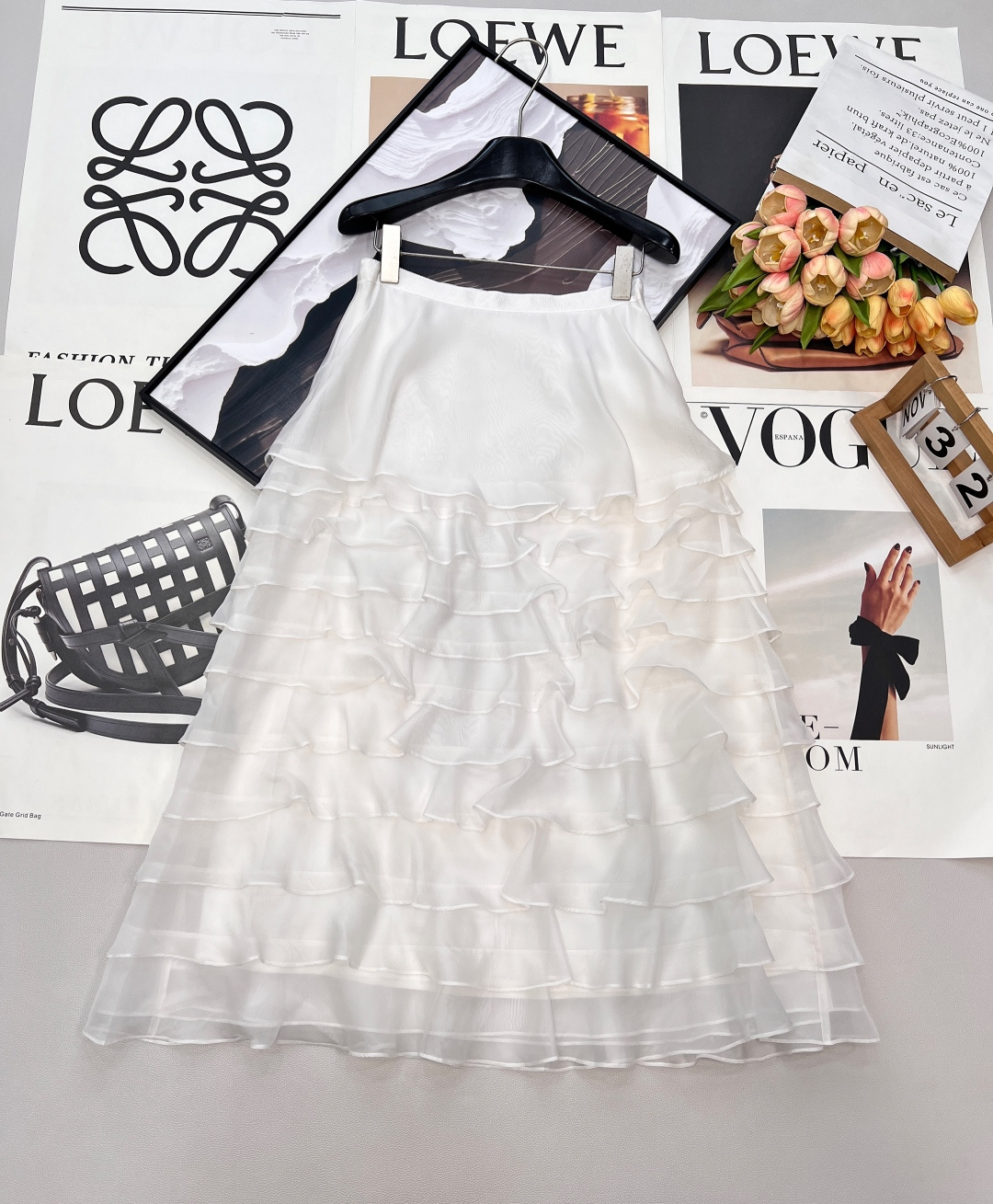 NO:731896,Dior26SS new mesh mulberry silk high-waist cake skirt, this is a skirt with its own fairy spirit. The layers of mesh and mulberry silk interweave to create a romantic and high-end texture. It is as light and elegant as clouds when walking. It is an excellent item to create an elegant atmosphere. -  The inner layer of the double-layer luxury fabric is made of 6A-grade mulberry silk, which feels silky and skin-friendly and has a soft light texture; the outer layer is made of custom-made imported mesh, which is light, transparent, stiff and not easy to wrinkle, and shows rich layers under different lights. - The soft cream beige color is not picky on the skin tone, and comes with a gentle filter, which makes the human temperament warm and elegant. - The delicate waistband is designed with elastic knitting, which combines comfort and fit, and the invisible piping process is exquisite and traceless. -  The tiered cake skirt has more than ten layers of mesh made of staggered cutting technology. The layers are stacked but not bloated. It sways like a wave when you walk, giving it a dynamic beauty. - The high-waisted design can accurately enhance the waistline and optimize the body proportions. When paired with a short top, it can create a 'three-seven-point' golden figure. - The edges of the irregular skirt are beveled, which makes it visually more agile and elegant. It can cleverly modify the leg lines and is friendly to the pear-shaped figure. Style and matching -  Pair elegant commuting with a silk shirt + pointed-toe high heels to create an intellectual yet feminine workplace look. - Pair with a camisole + Mary Jane shoes for a romantic date, and easily capture the pure lustful atmosphere, making it the best choice for a heart-stopping date. - Pair with a satin top + pearl earrings at a dinner party to instantly transform into an elegant goddess, showing a luxurious look under the light. Complete with three standards and two colors. Size sml code, dior, mary jane, high  heels,skirts,shirts,real silk,gold,19860909Dior26SS新款网纱桑蚕丝高腰蛋糕半裙,这是一条自带仙气的半裙,层层叠叠的网纱与桑蚕丝交织出浪漫又高级的质感,行走间如云朵般轻盈飘逸,是打造优雅氛围感的绝佳单品. - 双层奢配面料内层采用6A级桑蚕丝,触感丝滑亲肤,自带柔光质感；外层是定制进口网纱,轻盈通透且挺括不易皱,在不同光线下呈现丰富层次. - 奶油米色调柔和的奶油米色不挑肤色,自带温柔滤镜,衬得人气质温润雅致. - 细腻腰头腰头采用弹力针织设计,兼具舒适度与贴合感,隐形嵌边工艺精致无痕. - 层叠蛋糕裙摆十余层网纱采用错位剪裁工艺,层层叠叠却不显臃肿,走动时如波浪般摇曳生姿,自带动态美感. - 高腰剪裁高腰设计能精准提升腰线,优化身材比例,搭配短上衣可打造“三七分”黄金身材. - 不规则裙摆裙摆边缘采用斜切工艺,视觉上更显灵动飘逸,能巧妙修饰腿部线条,对梨形身材友好. 风格与搭配 - 优雅通勤搭配真丝衬衫+尖头高跟鞋,打造知性又不失柔美的职场造型. - 浪漫约会搭配吊带背心+玛丽珍鞋,轻松拿捏纯欲氛围感,是心动约会的不二之选. - 晚宴派对搭配缎面小上衣+珍珠耳饰,瞬间化身优雅女神,在灯光下尽显奢华质感.三标齐全,两色出 尺码sml 编码,,dior,mary jane,high heels,skirts,shirts,real silk,gold,,Women's clothing