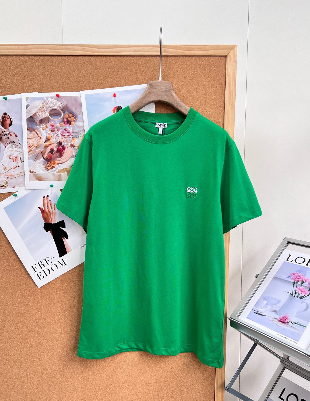 NO:911682,LOEW's new basic round-neck short-sleeved T-shirt with logo embroidery is made of 99% combed cotton and 1% spandex blend. It combines the skin-friendly and breathable properties of natural cotton with the anti-deformation and resilience properties of elastic fibers, effectively avoiding the problems of loose body and saggy collar under daily wear.  The collar uses a ribbed barrel collar of the same color, and the flat seam sewing process is used to reinforce the collar seat. The collar line is even and regular, and an anti-wear strip is installed on the back collar to reduce the friction and discomfort between the collar and the back of the neck.  The brand's iconic two-color Anagram three-dimensional embroidery is implanted on the left chest. The main body of the embroidery thread is polyester fiber, using high-density coiled embroidery stitches. The outline of the pattern is crisp and not soft. The embroidery backing is treated with a thin non-woven fabric pad to avoid  The fabric in the embroidery-free area is wrinkled and see-through. The body adopts a straight and loose fit, and the side seams adopt flat sewing technology. The hem is reinforced with double-needle folding and sewing, and the cuffs simultaneously use the same specification double-needle closing technology to ensure that they are not easy to curl or fall off after washing.  Full-width dip dyeing with highly saturated green reactive dyes, the color fastness meets the standard. The ready-made garments are pre-shrunk and washed, which greatly reduces the risk of shrinkage in the first wash. It is suitable for multi-scenario layering and single-matching needs, and has three complete standards!  Big shipment!  Size sml code,,loewe,T-shirt,tees,t-shirt,19860909LOEW新款logo刺绣基础圆领短袖T恤,采用99精梳棉搭配1氨纶混纺配比,兼具天然棉料的亲肤透气属性与弹性纤维赋予的抗形变回弹性能,有效规避日常穿着下的衣身松垮、领口塌边问题 领部选用同色系罗纹圆筒领,采用平缝包边车缝工艺加固领座,领围走线均匀规整,后领处设置防磨压条,弱化领口与后颈的摩擦不适感 左胸定位植入品牌标志性Anagram双色立体刺绣,绣线主体为聚酯纤维,采用高密度盘绕刺绣针法,纹样轮廓挺括不软塌,刺绣底衬做薄款无纺布衬垫处理,避免刺绣区域面料起皱透底.衣身采用直筒宽松版型,侧缝采用平车锁边工艺,下摆双针折边车缝加固,袖口同步运用同规格双针收边工艺,保证洗水后不易卷边、脱线 高饱和绿色活性染料全幅浸染,色牢度达标,成衣经预缩水洗工艺处理,大幅降低初次水洗的缩率风险,适配多场景叠穿与单搭需求,三标齐全！大货出！ 尺码sml 编码,,loewe,T-shirt,tees，t-shirt,,Women's clothing