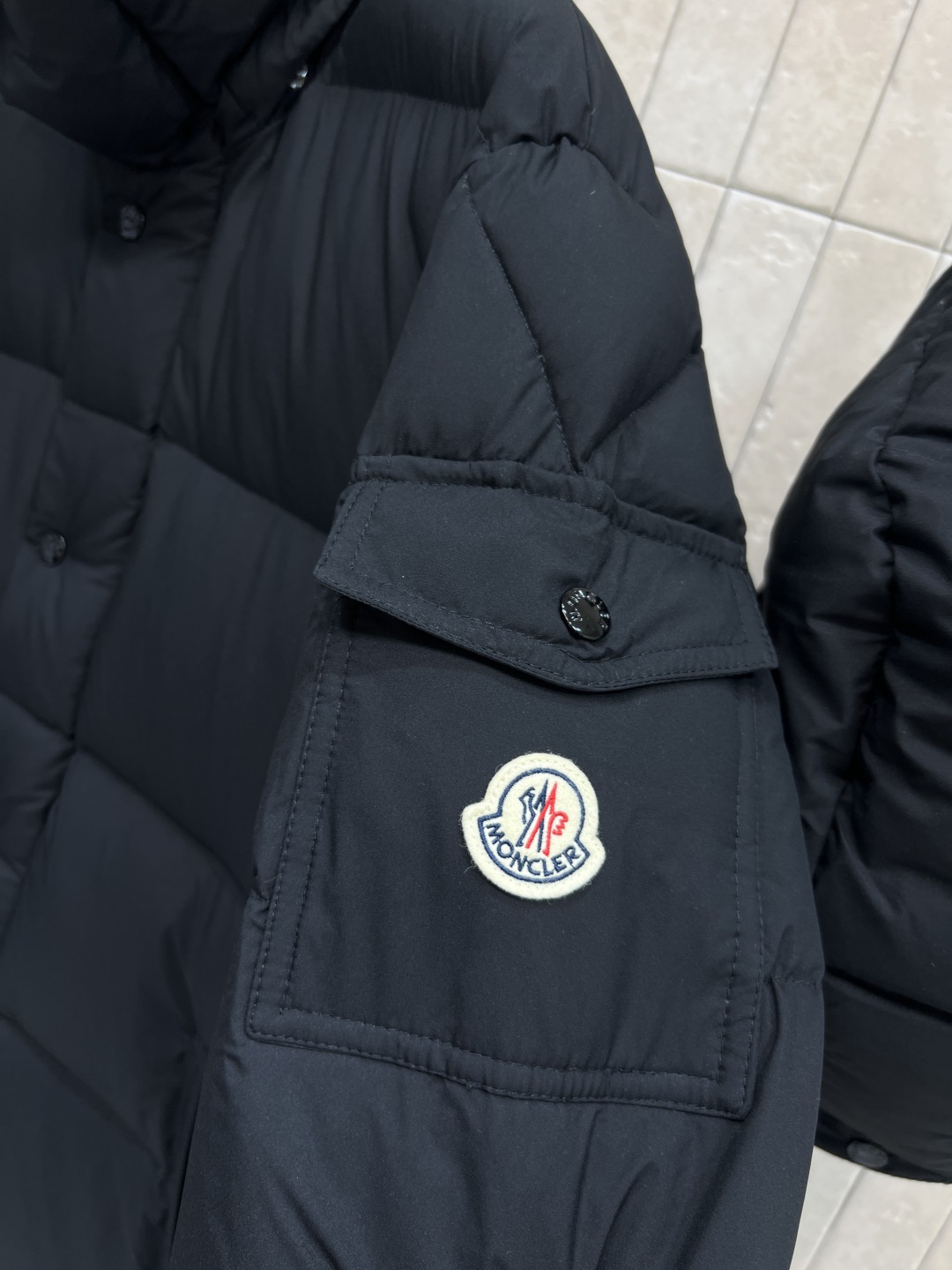M家 25秋冬新款 连帽长款羽绒服 立体H版型剪裁双侧口袋装饰侧肩经典的品牌刺绣徽章包包点缀 时髦帅气保