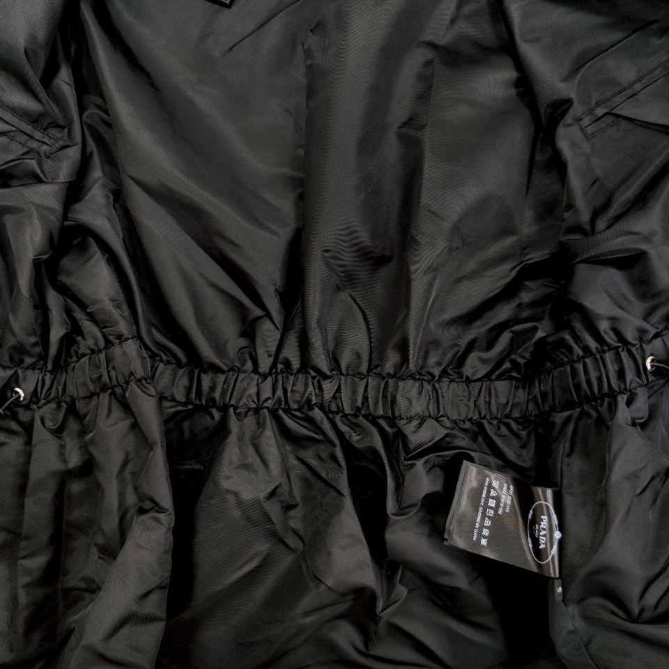 Top Prada hooded windbreaker with drawstring, large pockets, and waist-cinching design. Nylon fabric, slim fit. Sizes S, M, L.-Big cat